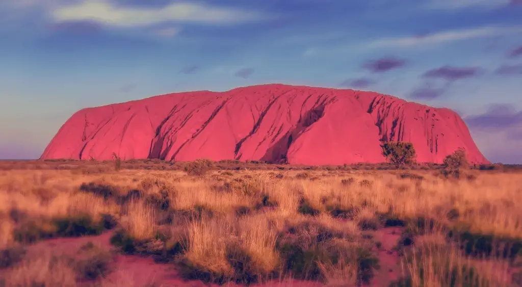 Uluru at sunset in the Central Australian desert, sacred to the Anangu people
