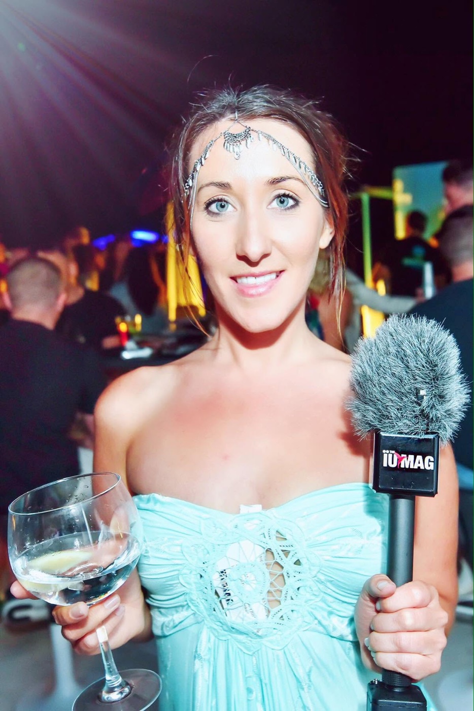 Jodie Louise holding a magazine microphone at an Ibiza event