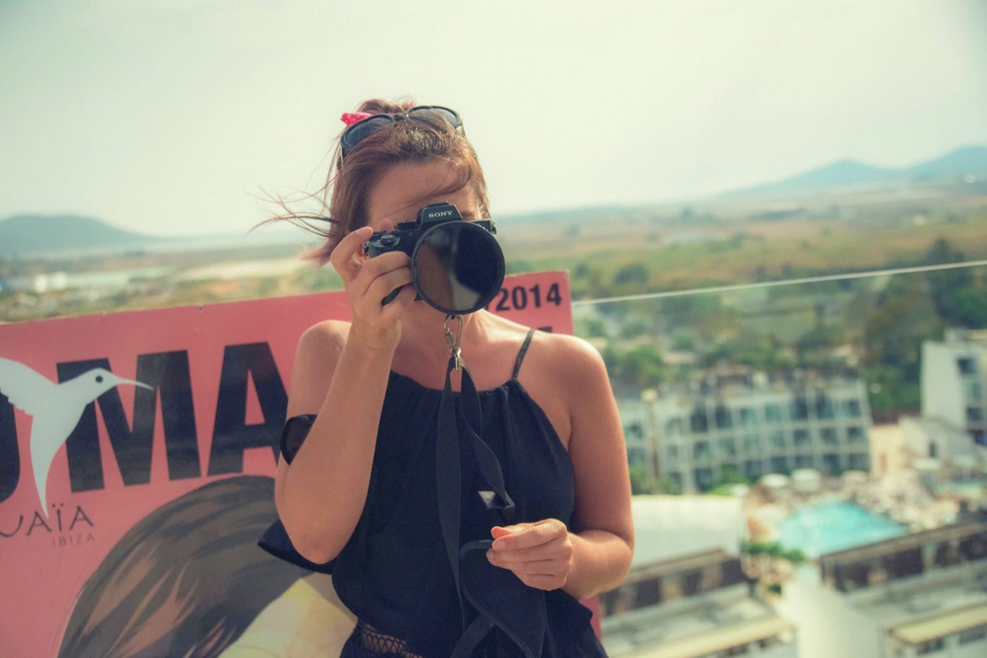 Jodie Louise shooting with her camera on a rooftop in Ibiza