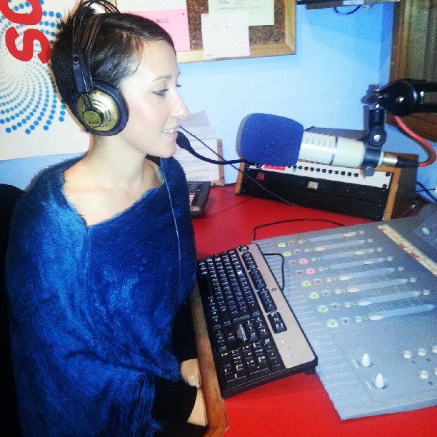 Jodie Louise speaking on the radio in the studio