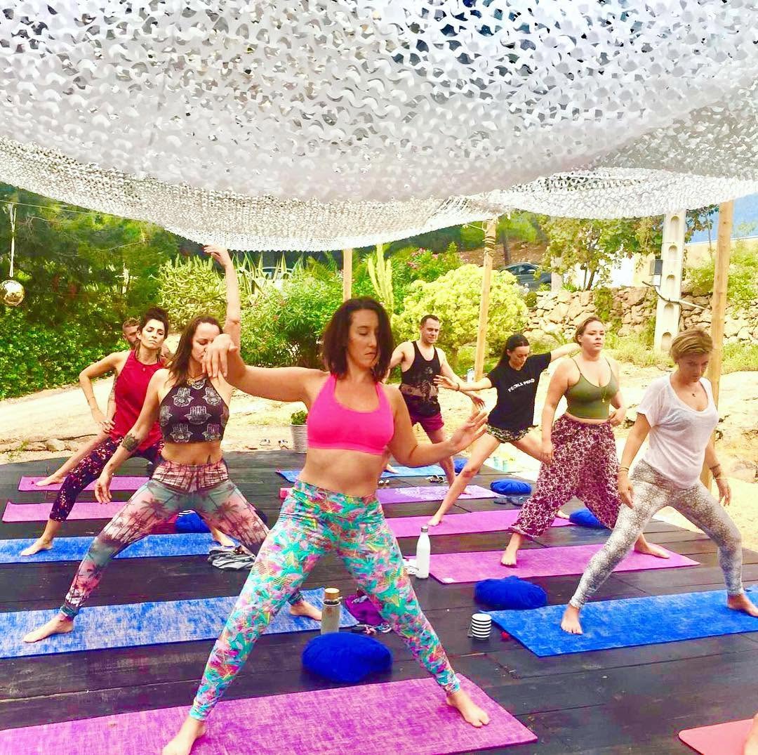 Jodie Louise practising with a group at a yoga retreat in Ibiza