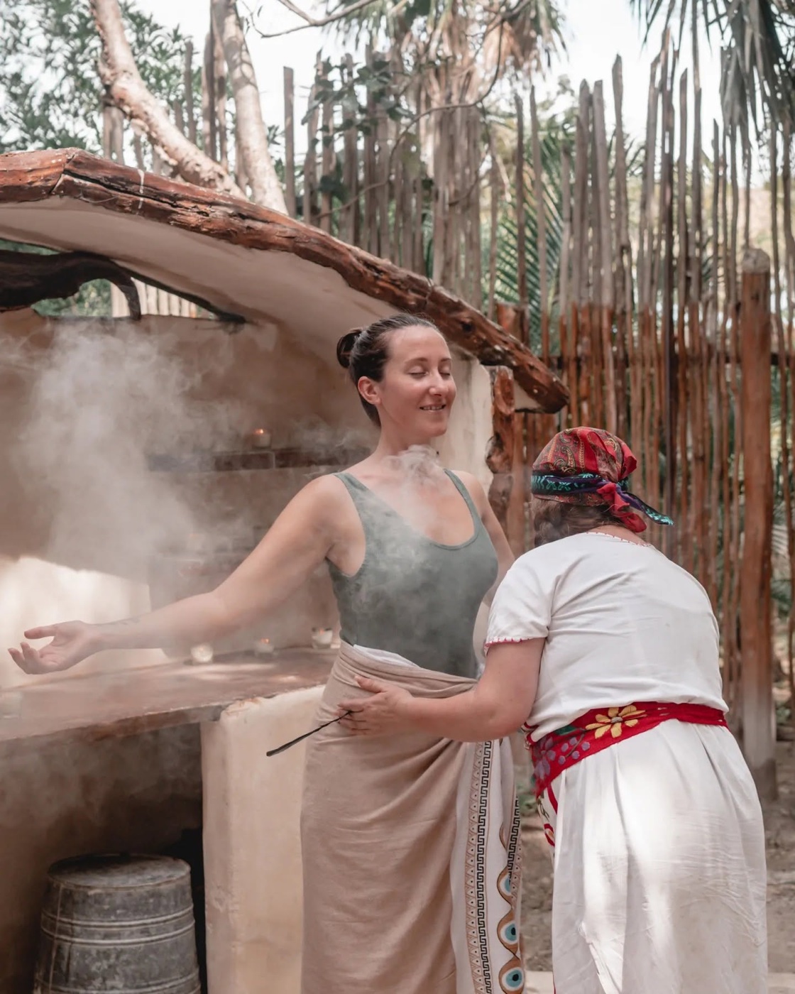 Jodie Louise beside a Mayan woman at a temazcal in Mexico